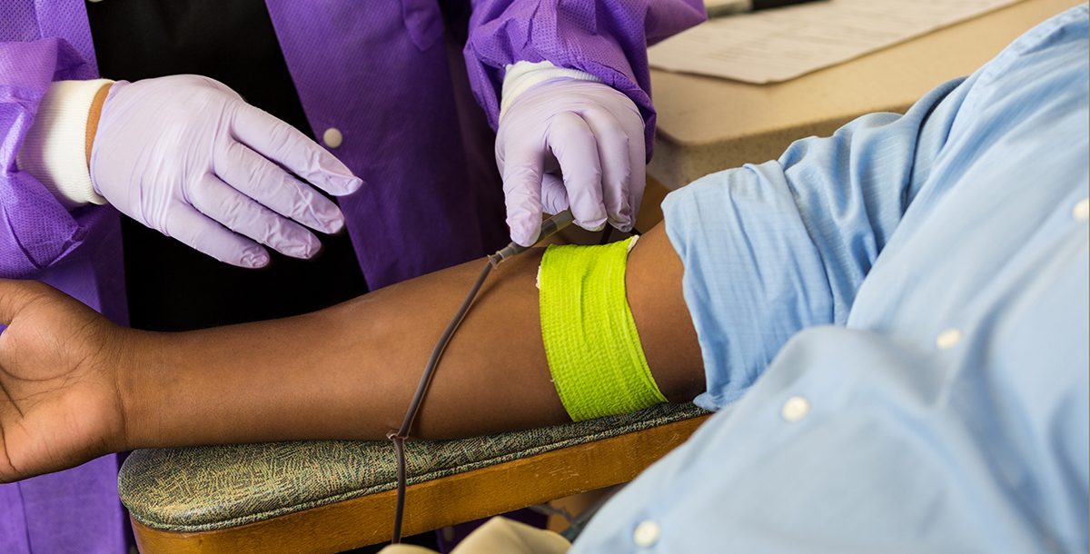 Individual donating blood during COVID-19
