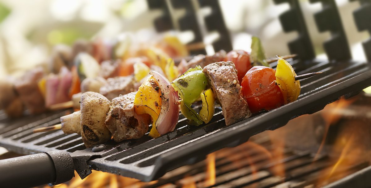 someone grilling healthy chicken kabobs during the summer