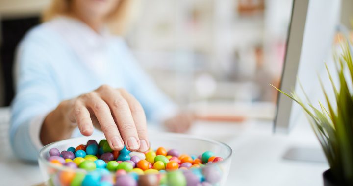 A woman stress snacking candy at home during COVID-19