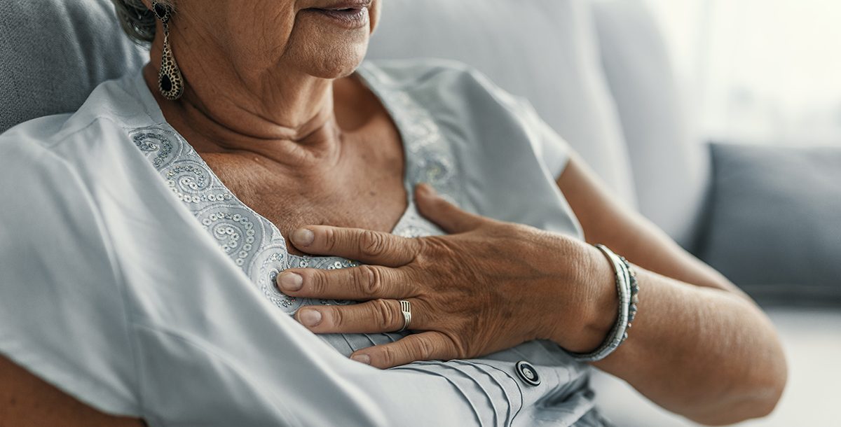 A woman experiencing gas pain in her chest.