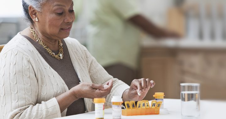 A woman managing her medications at home during COVID-19.