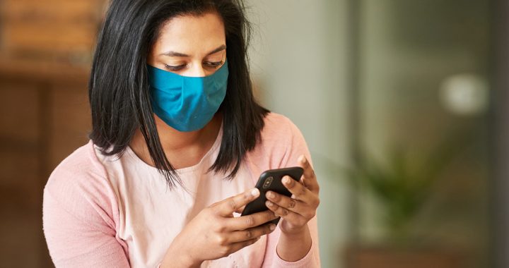 A woman receiving a COVID-19 contact tracing alert on her phone.