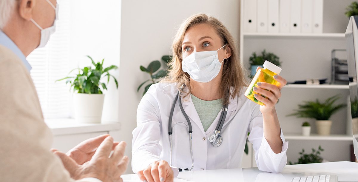 A primary care provider going over a patient's medications during their appointment.