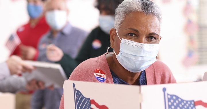 A woman voting at the polls.