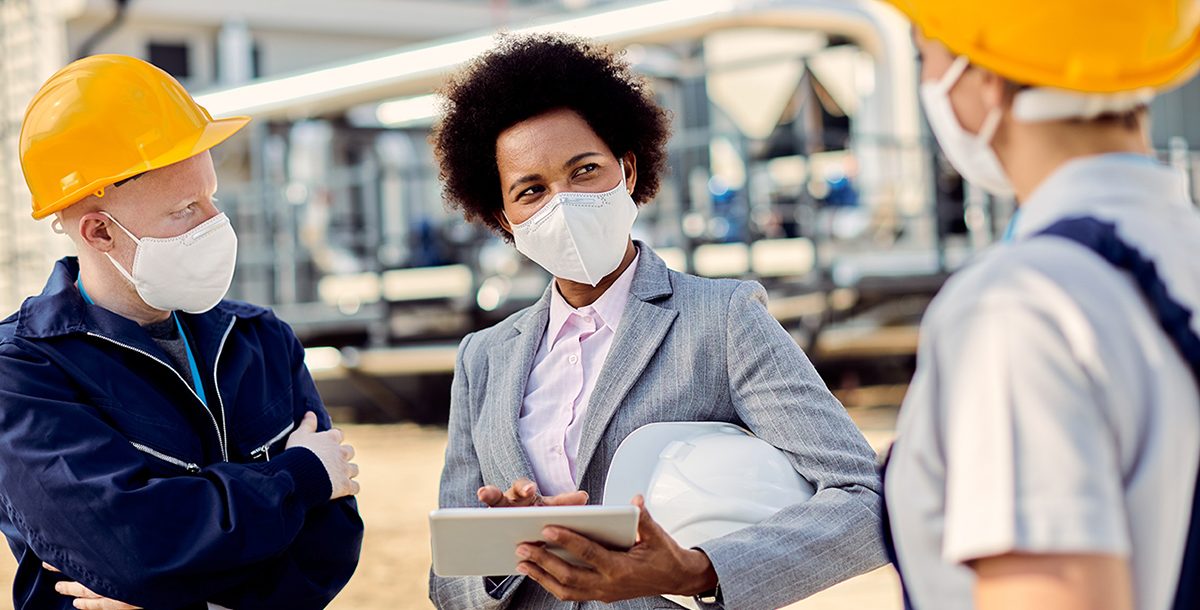 People wearing face mask while meeting in person.