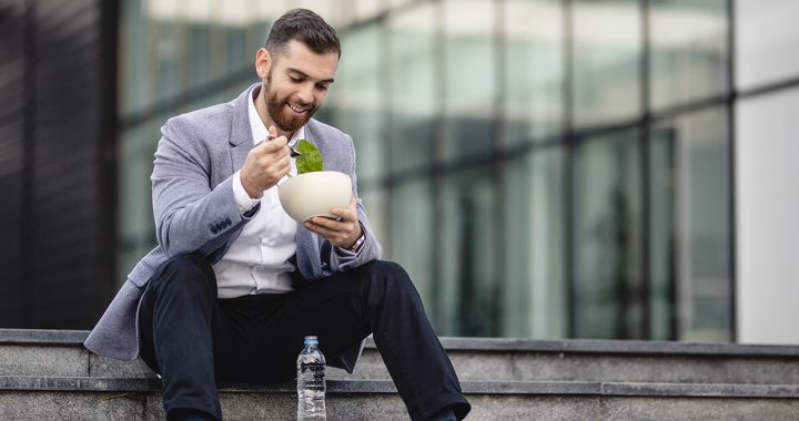 A young man taking a lunch break outside.