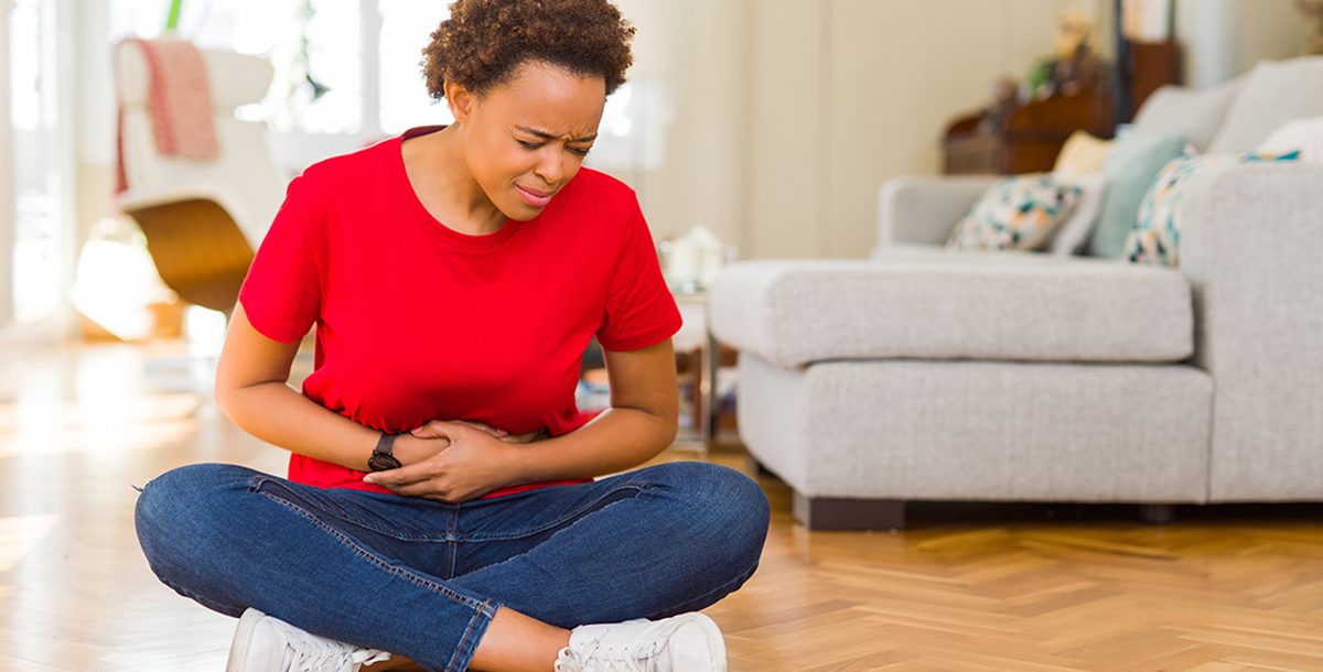 A woman experiencing a sore stomach.