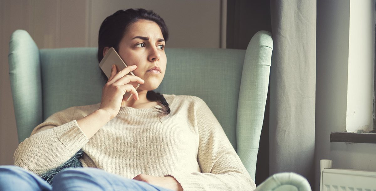 A woman participating in a therapy session over the phone.