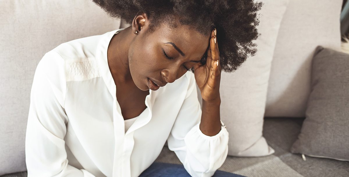 A woman experiencing a migraine or sinus headache.