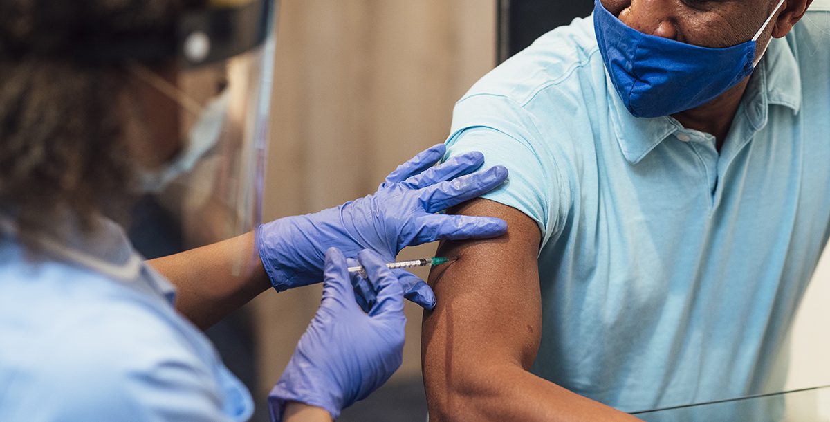 A man receiving his covid-19 vaccine.