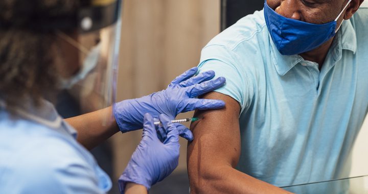 A man receiving his covid-19 vaccine.