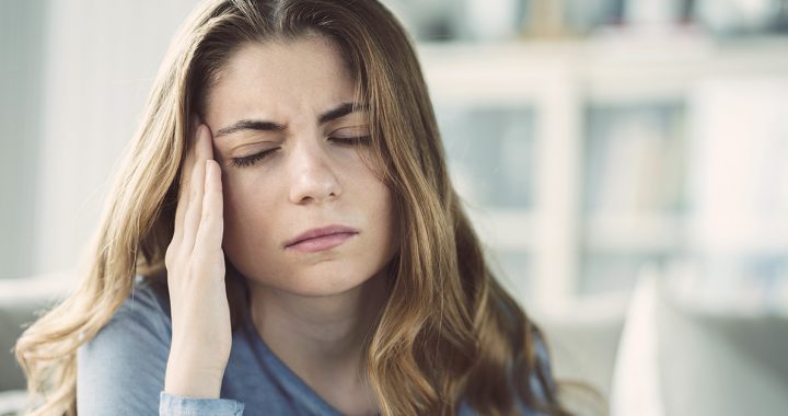 A woman experiencing side effects from her COVID-19 vaccine.