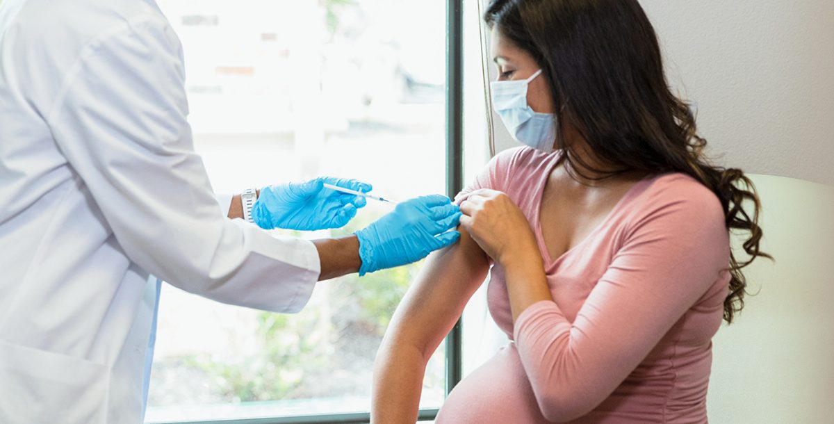 A pregnant woman getting her COVID-19 vaccine.