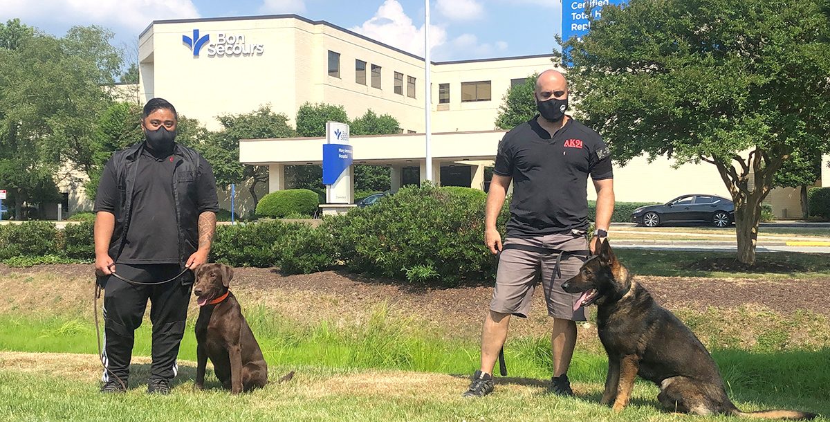 AK9I dogs and their trainers outside of Mary Immaculate Hospital