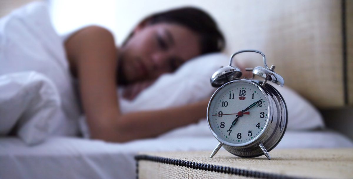 A sleeping woman adjusting to daylight saving time.