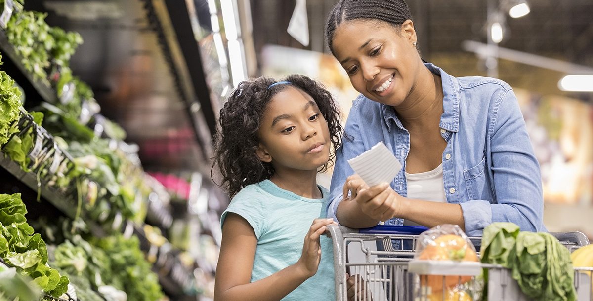 A mother and daughter grocery shopping together.