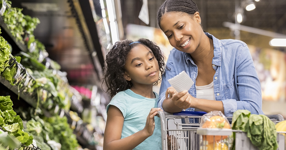 A mother and daughter grocery shopping together.