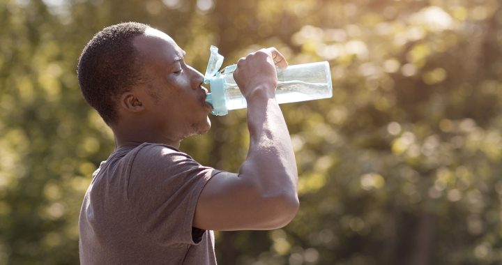 A man staying hydrated in the summer