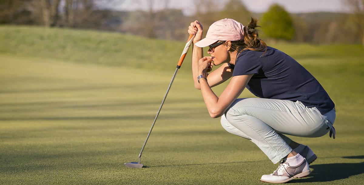 A woman playing golf.